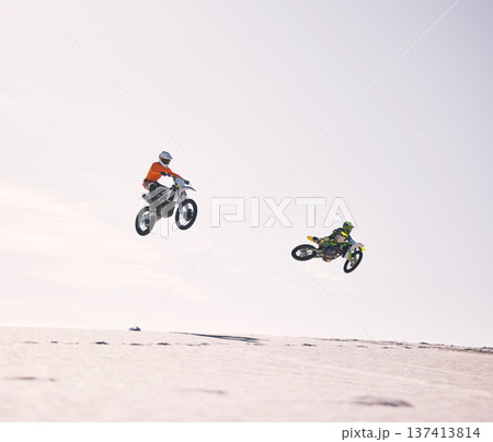 Dune, jump and men on motorbike together for practice, training and extreme sports energy in nature. Professional dirt biking challenge, friends and danger with motorcycle competition on desert hill. 137413814