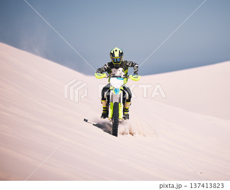 Dune, motorbike and man athlete training in desert for extreme sports race or competition. Fitness, sand and male biker on hill for dirt biking challenge, stunt or skill for practice with motorcycle. 137413823