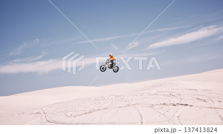 Bike, mockup and jump with a man in the desert riding a vehicle for adventure or adrenaline. Motorcycle, speed and training on sand with an athlete outdoor in nature for power or active competition 137413824