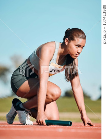 Start, running and relay with woman on race track with baton for sports, competition and marathon. Exercise, health and wellness with runner in stadium for challenge, speed and energy performance Start, running and relay with woman on race track with baton for sports, competition and marathon. Exercise, health and wellness with runner in stadium for challenge, speed and energy performance 137413989