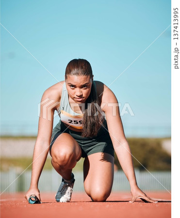 Start, running and fitness with woman on race track with baton for sports, competition and marathon. Exercise, health and wellness with runner in stadium for challenge, speed and energy performance 137413995