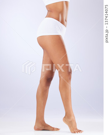 Legs, feet or woman in studio for body health or wellness on white background for diet to lose weight. Self care, barefoot or model in underwear with smooth stomach, glow or skin at spa for beauty 137414075