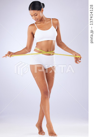 Fitness, body and progress with woman and tape in studio for weight loss, detox and workout. Wellness, diet and health with person on white background for results, cosmetics and goal measurement Fitness, body and progress with woman and tape in studio for weight loss, detox and workout. Wellness, diet and health with person on white background for results, cosmetics and goal measurement 137414128