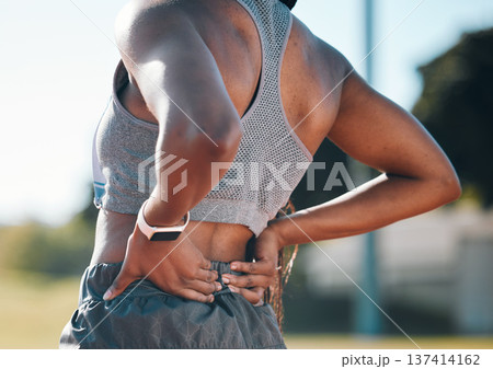Back pain, fitness and athlete with injury problem in a stadium due to outdoor exercise, training or workout. Hurt, inflammation and person with muscle strain, ache or body tension by the spine 137414162
