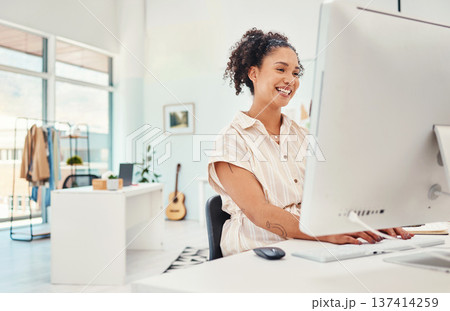 Computer, fashion and design with a creative woman at work in her office for modern or artistic style. Smile, workshop and technology with a happy young designer working in a studio for creativity 137414259