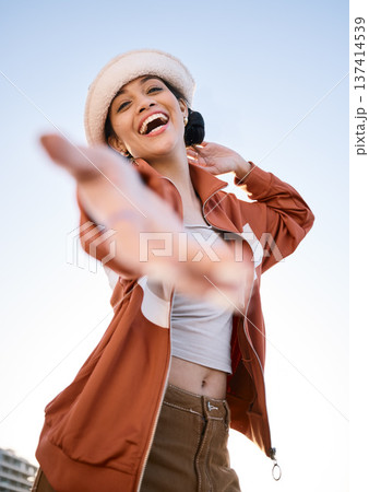 Excited woman, portrait and helping hand, offer and invitation outdoor in low angle. Funny, palm and person giving assistance for support, care and laughing in acceptance of handshake sign to welcome Excited woman, portrait and helping hand, offer and invitation outdoor in low angle. Funny, palm and person giving assistance for support, care and laughing in acceptance of handshake sign to welcome 137414539