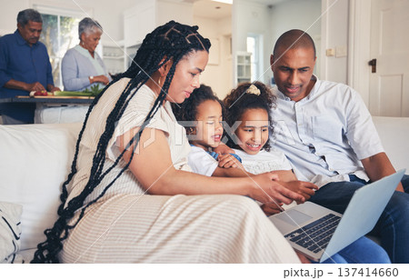 Laptop, social media or gaming with parents and children on a sofa together in the living room of their home. Computer, website and a family on the internet for browsing while in a house to relax Laptop, social media or gaming with parents and children on a sofa together in the living room of their home. Computer, website and a family on the internet for browsing while in a house to relax 137414660