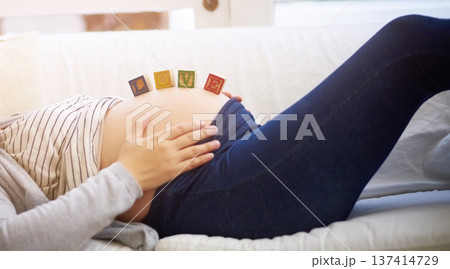 Hands, pregnant woman or stomach with building blocks on sofa, love or bonding for maternal attachment. Connection, belly and person with pregnancy in home, toy or care for relationship development Hands, pregnant woman or stomach with building blocks on sofa, love or bonding for maternal attachment. Connection, belly and person with pregnancy in home, toy or care for relationship development 137414729