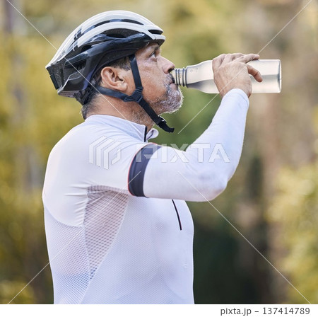 Cycling, fitness and senior man drinking water in park for hydration during training exercise in nature. Bottle, thirsty and elderly athlete with electrolytes break or sports liquid in forest workout Cycling, fitness and senior man drinking water in park for hydration during training exercise in nature. Bottle, thirsty and elderly athlete with electrolytes break or sports liquid in forest workout 137414789