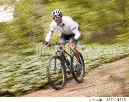 Fast, cycling and man on a bike in nature for fitness, sports or a competition. Energy, mountains and a male cyclist on a bicycle in the woods with speed for exercise, cardio or training in a forest Fast, cycling and man on a bike in nature for fitness, sports or a competition. Energy, mountains and a male cyclist on a bicycle in the woods with speed for exercise, cardio or training in a forest 137414838