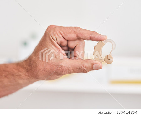 Hearing aid, hands and person with disability for medical support, healthcare innovation and volume. Closeup of deaf patient with audiology implant to help sound waves, amplifier or improve listening Hearing aid, hands and person with disability for medical support, healthcare innovation and volume. Closeup of deaf patient with audiology implant to help sound waves, amplifier or improve listening 137414854