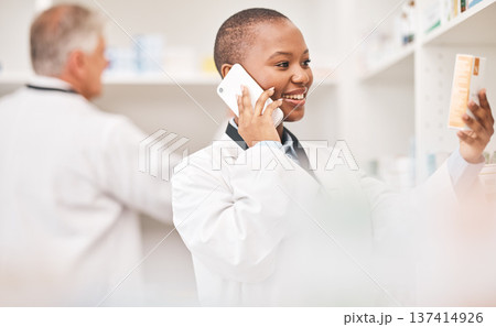 Pharmacy, phone call and woman with medicine box while reading information. African person or pharmacist talking on smartphone for telehealth, consultation or customer service and product label 137414926