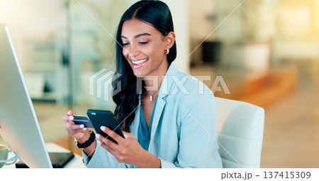 Happy woman making online payment with phone and bank card for typing credit details into online banking app. Young business woman enjoying virtual shopping or wireless purchase while sitting inside Happy woman making online payment with phone and bank card for typing credit details into online banking app. Young business woman enjoying virtual shopping or wireless purchase while sitting inside 137415309