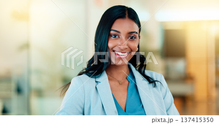 Successful female executive typing or reading an email. Confident business woman using a computer at work. Selective focus on beautiful lady sitting in an office chair, smiling. 137415350