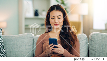 Phone, social media and happy woman texting on a dating app and smiling on the weekend at home on the couch. Smile, chatting and young girl loves typing a message on a social networking website Phone, social media and happy woman texting on a dating app and smiling on the weekend at home on the couch. Smile, chatting and young girl loves typing a message on a social networking website 137415431