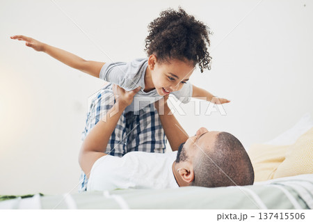 Happy, fun and father with girl on bed playing, bonding and airplane game for dad with child in home. Family, love and playful energy, man holding daughter in air and laughing in bedroom together. 137415506