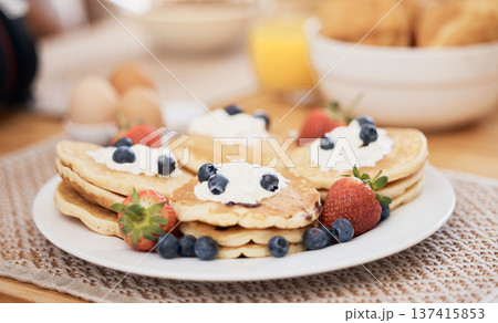 Pancakes, breakfast and fruits on table in home in the morning for protein. Bread waffle, cream and food for eating, healthy diet and strawberry in wellness nutrition, blueberry and egg meal on plate Pancakes, breakfast and fruits on table in home in the morning for protein. Bread waffle, cream and food for eating, healthy diet and strawberry in wellness nutrition, blueberry and egg meal on plate 137415853