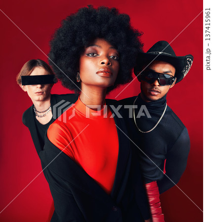 Fashion, portrait and a group of people, style and retro clothes on a red studio background for art, punk and creative aesthetic. Friends, rock or a black woman with men with vintage or trendy outfit 137415961