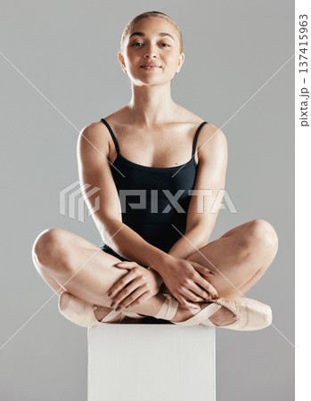 Ballet, dancer and portrait of woman in studio sitting on podium with calm, posture and happy face on grey background. Dance, class or ballerina with a smile in costume and girl in pointe shoes Ballet, dancer and portrait of woman in studio sitting on podium with calm, posture and happy face on grey background. Dance, class or ballerina with a smile in costume and girl in pointe shoes 137415963