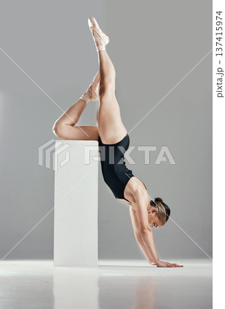 Balance, ballerina or woman in studio on a handstand, block or platform for elegant routine or creative freedom. Flexible, dancer or girl ballet dancing or training to exercise on white background Balance, ballerina or woman in studio on a handstand, block or platform for elegant routine or creative freedom. Flexible, dancer or girl ballet dancing or training to exercise on white background 137415974