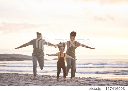 Travel, freedom and a family at the beach during sunset for flying, playing and bonding at the ocean. Smile, holiday and an interracial child, mother and father at the sea for a vacation or summer Travel, freedom and a family at the beach during sunset for flying, playing and bonding at the ocean. Smile, holiday and an interracial child, mother and father at the sea for a vacation or summer 137416008