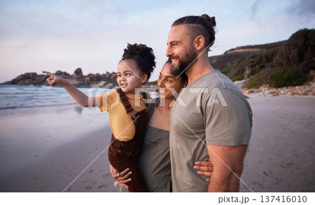Child, pointing and happy family on beach at sunset on summer, vacation or bonding together on tropical holiday in Costa Rica. Ocean, view and interracial parents support girl or kid show with hand 137416010