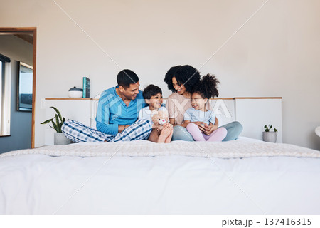Happy, smile and family on bed talking, bonding and relaxing together with love at their home. Happiness, excited and young children speaking to their parents from Colombia in the room of their house Happy, smile and family on bed talking, bonding and relaxing together with love at their home. Happiness, excited and young children speaking to their parents from Colombia in the room of their house 137416315
