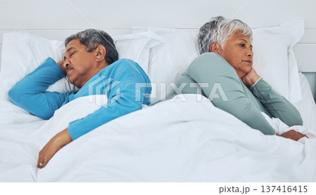 Sleeping, fighting and a senior couple in a bed with insomnia in a marriage together. Conflict, tired and elderly man and woman in the bedroom for rest in divorce and a nap with thinking in a house 137416415