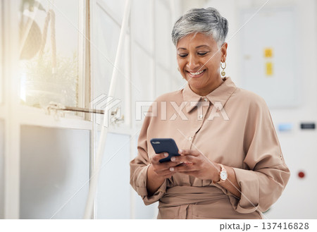 Senior woman, phone text and networking in a office with a smile and mobile planning for digital work. Person, female professional and happy from contact and social media scroll for business online 137416828