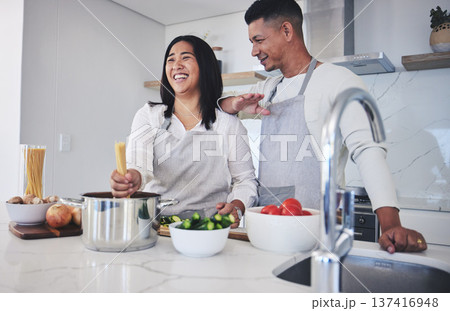 Laughing, cooking and love with couple in kitchen for food, health and lunch recipe. Happy, nutrition and dinner with man and woman and pasta at home for diet, wellness and romance together 137416948