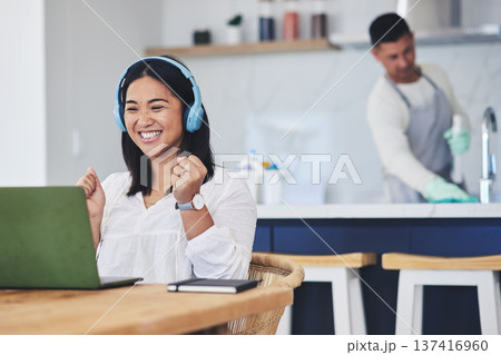 Laptop, music and remote work with a winner woman in her home reading news about a bonus or promotion. Computer, celebration and headphones with a happy young entrepreneur cheering freelance success 137416960