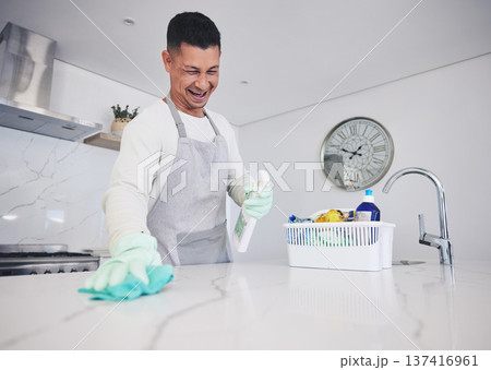 Kitchen, cleaning and happy man with spray for kitchen, counter or surface care at home. Housework, spring clean and male person smile while using bacteria, dust and dirt control product in a house 137416961