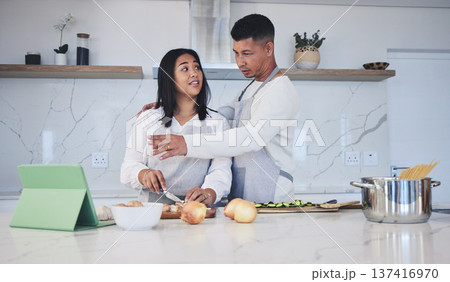 Tablet, cooking and couple in a kitchen, recipe and bonding with love, marriage and conversation. Home, man and woman with technology, online reading and nutrition with instructions and prepare lunch 137416970