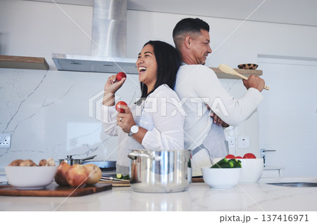 Happy couple, food and fun cooking in kitchen together for healthy eating or natural nutrition at home. Man and woman enjoying teamwork or bonding in happiness for breakfast, lunch or supper meal 137416971