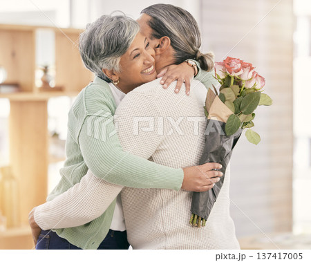 Mature couple, flowers and hug at home for anniversary, birthday or valentines celebration. Surprise, love and roses or bouquet with a man and woman for healthy marriage, happiness and romance Mature couple, flowers and hug at home for anniversary, birthday or valentines celebration. Surprise, love and roses or bouquet with a man and woman for healthy marriage, happiness and romance 137417005