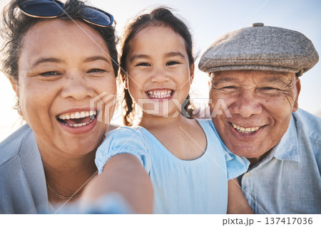 Smile, selfie and portrait of girl with grandparents in nature on fun family vacation or adventure. Happy, memory and child bonding and taking a picture with her grandmother and grandfather on a trip Smile, selfie and portrait of girl with grandparents in nature on fun family vacation or adventure. Happy, memory and child bonding and taking a picture with her grandmother and grandfather on a trip 137417036