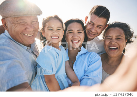 Happy, selfie and portrait of big family on the beach for tropical vacation or adventure together. Smile, love and girl child taking picture with her parents and grandparents by the ocean on holiday. Happy, selfie and portrait of big family on the beach for tropical vacation or adventure together. Smile, love and girl child taking picture with her parents and grandparents by the ocean on holiday. 137417040