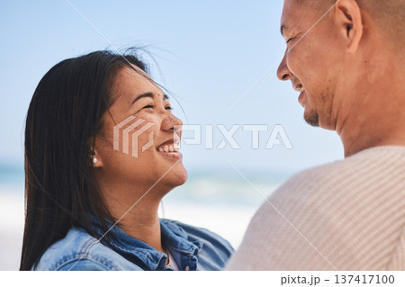 Happy, couple and love at the beach together for travel, date or a vacation in the summer. Smile, marriage and a man and woman with care on a holiday, the sea for a honeymoon or outdoor walking Happy, couple and love at the beach together for travel, date or a vacation in the summer. Smile, marriage and a man and woman with care on a holiday, the sea for a honeymoon or outdoor walking 137417100