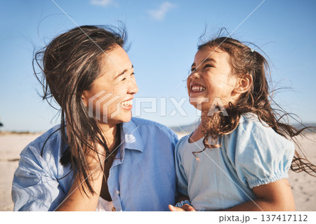 Laughing, care and a mother and child at the beach for family, travel or summer freedom. Happy, young and a mom with a girl kid at the ocean for a holiday, bonding or together with love at the sea Laughing, care and a mother and child at the beach for family, travel or summer freedom. Happy, young and a mom with a girl kid at the ocean for a holiday, bonding or together with love at the sea 137417112
