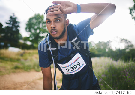 Runner man, race and tired in nature, thinking and rest for sweat, breathe or vision in woods for triathlon. Athlete guy, face and idea for strategy, fatigue or burnout in forest, marathon or hiking] 137417160