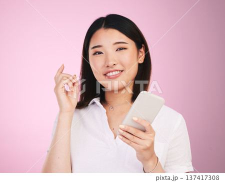 Search, phone and social media with portrait of woman in studio for networking, communication and internet. Website, post and gen z with Asian person on pink background for technology and mobile app Search, phone and social media with portrait of woman in studio for networking, communication and internet. Website, post and gen z with Asian person on pink background for technology and mobile app 137417308