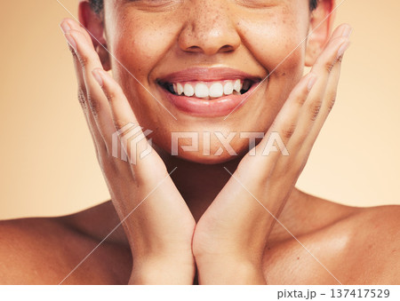 Skincare, smile and hands on woman face in studio for cosmetic, wellness and dermatology on brown background. Happy, beauty and lady model excited for glowing skin, results or self love cosmetology 137417529