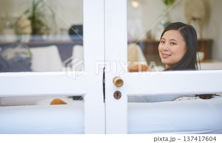 Woman, happy and relax on sofa in home by window with teddy bear, comfort and chill in living room. Asian person, smile and rest on couch with plush toy, portrait or break at apartment in Cambodia Woman, happy and relax on sofa in home by window with teddy bear, comfort and chill in living room. Asian person, smile and rest on couch with plush toy, portrait or break at apartment in Cambodia 137417604