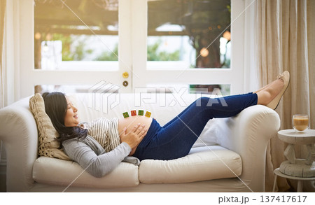 Relax, building blocks and stomach with pregnant woman on sofa in home for growth, baby news or love. Pregnancy announcement, wooden toys and support with person and belly in living room of apartment Relax, building blocks and stomach with pregnant woman on sofa in home for growth, baby news or love. Pregnancy announcement, wooden toys and support with person and belly in living room of apartment 137417617