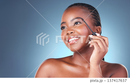 Face brush, eyebrow and beauty of a woman with dermatology, natural makeup and smile. Happy African person on blue background with brow cosmetics, mascara and facial glow for self care in studio 137417637