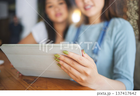 Restaurant, tablet and hands of women for online menu, food options and order for lunch, meal or dinner. Coffee shop, cafe and happy friends on digital tech for social media review, website and app Restaurant, tablet and hands of women for online menu, food options and order for lunch, meal or dinner. Coffee shop, cafe and happy friends on digital tech for social media review, website and app 137417642