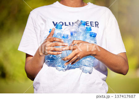Volunteer hands, plastic bottle and park for community service, recycling and climate change or earth day project. Person volunteering outdoor or nature for eco friendly cleaning or nonprofit support Volunteer hands, plastic bottle and park for community service, recycling and climate change or earth day project. Person volunteering outdoor or nature for eco friendly cleaning or nonprofit support 137417687