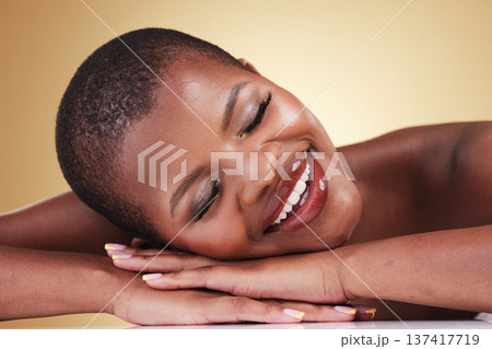 Makeup, face and beauty of happy woman in studio for self care, skin glow or cosmetics. Closeup of African aesthetic model person with facial shine, dermatology or relax on hands on beige background Makeup, face and beauty of happy woman in studio for self care, skin glow or cosmetics. Closeup of African aesthetic model person with facial shine, dermatology or relax on hands on beige background 137417719