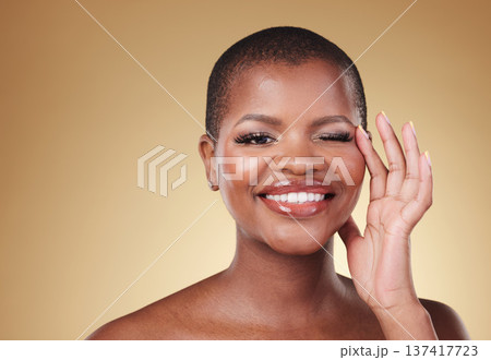 Beauty, makeup and portrait of a black woman in studio with hands on face for skin care, glow and cosmetics. African model person with facial shine, dermatology and wellness on a beige background Beauty, makeup and portrait of a black woman in studio with hands on face for skin care, glow and cosmetics. African model person with facial shine, dermatology and wellness on a beige background 137417723