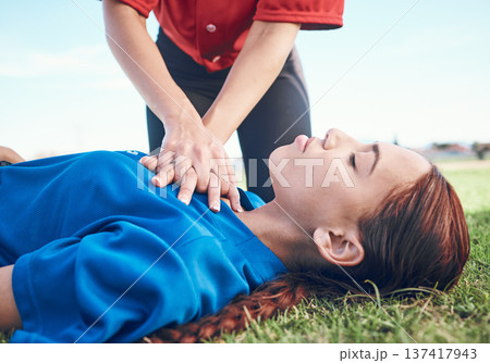 Cpr, outdoor and hands on chest, women and help on a field, resuscitation and medical emergency. Closeup, player outside and heart attack with volunteer, accident and first aid to rescue a person Cpr, outdoor and hands on chest, women and help on a field, resuscitation and medical emergency. Closeup, player outside and heart attack with volunteer, accident and first aid to rescue a person 137417943